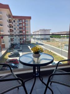 a table on a balcony with a view of a city at K2-SistersApartment in Podgorica
