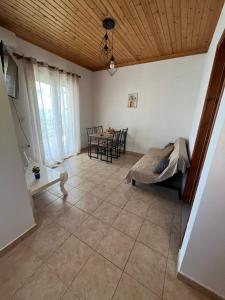 a living room with a couch and a table at Andrianas Apartment in Áyios Pétros