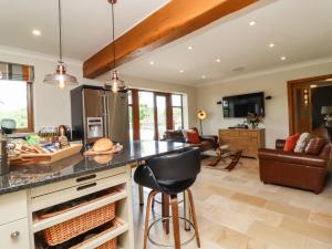a kitchen with a counter and a living room at Glen House in Bingley