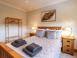 a bedroom with a bed with two pillows on it at Glen House in Bingley