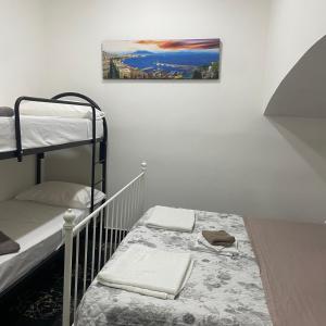 a room with two bunk beds and a picture on the wall at Cuore di Napoli in Naples