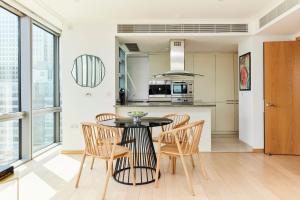 a kitchen and dining room with a table and chairs at The Canary Wharf Place - Stunning 2BDR Flat in London