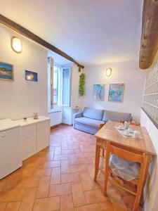 a living room with a couch and a table at Casedirio Apartment - Riomaggiore in Riomaggiore +9 photos