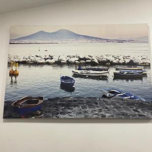 a painting of boats sitting in the water at Cuore di Napoli in Naples