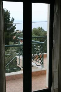 a view out of a window of a balcony at elgevacation villa 1 in Lagomandra