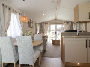 a kitchen and dining room with a table and chairs at Pams Place in Newquay