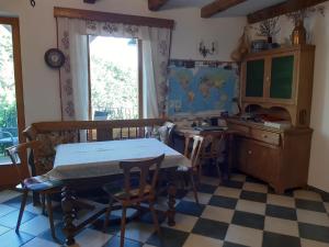 a kitchen with a table and chairs in a room at Hungária Vendégház in Eger
