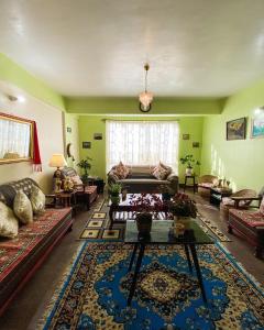 a living room with a couch and a table at Syangden Villa, Nagbeli BNB in Darjeeling