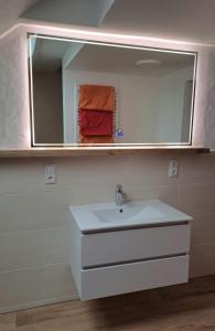 a bathroom with a sink and a mirror at Ferienwohnung Natalie in Kaisersesch