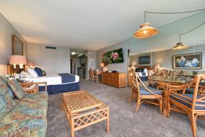 a hotel room with a king bed and a living room at Maui KaanapaliVilla A517 in Lahaina
