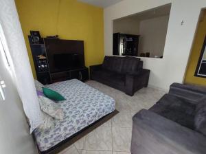 a living room with a couch and a couch and a chair at Casa Simples e Agradável da Lu in Alto Paraíso de Goiás