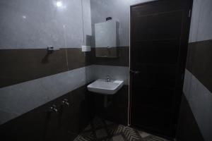 a bathroom with a sink and a mirror at New star homes in Kotamangalam