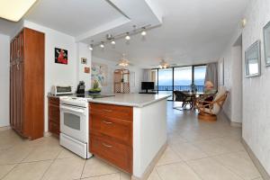 a kitchen with a counter and a dining room at Valley Isle 905 in Kahana