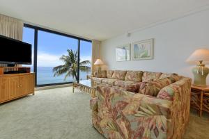 a living room with a couch and a flat screen tv at Mahana Resort #518 in Kahana