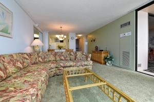 a living room with a couch and a coffee table at Mahana Resort #518 in Kahana