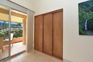 a wooden pivot door in a house with a balcony at Maui Kaanapali Villas #D271 in Lahaina