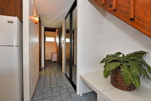 a hallway with a plant in a basket on a counter at Papakea Condo Unit D402 in Kahana