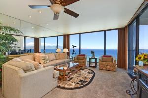 a living room with a couch and a ceiling fan at Mahana Resort #1104 in Kahana