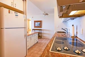 a kitchen with a refrigerator and a stove at Valley Isle #205 in Kahana
