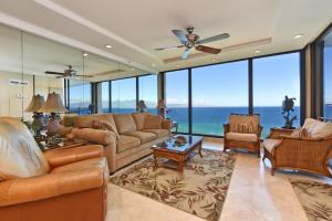 a living room with a couch and chairs and the ocean at Mahana Resort #1204 in Kahana