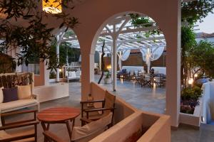 a patio with tables and chairs in a building at Villa Maria in Toroni