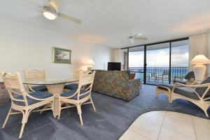 a living room with a table and chairs and a couch at Valley Isle #808 in Kahana