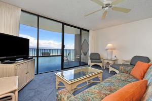 a living room with a couch and a flat screen tv at Valley Isle #808 in Kahana