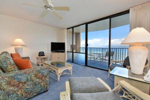 a living room with a couch and a view of the ocean at Valley Isle #808 in Kahana