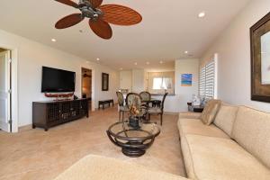 a living room with a couch and a ceiling fan at Kaanapali Plantation #52 Condo in Lahaina