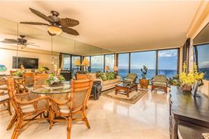 a living room with a table and chairs at Mahana Resort #1017 in Kahana