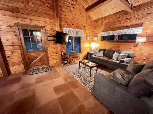 a living room with a couch and a tv in a cabin at Perfect Mountain Getaway in Stratton