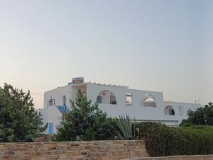 a white house with a fence in front of it at Andreana's House in Antiparos