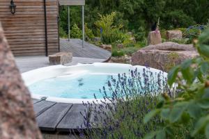 a jacuzzi tub sitting on a wooden deck at The Polchar - Aviemore in Aviemore