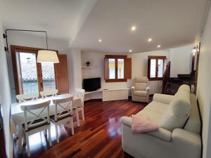 a living room with a table and a dining room at Can Manén in Camprodon