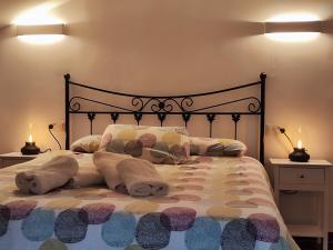 a bedroom with a large bed with pillows and blankets at Can Manén in Camprodon