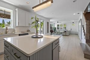 a kitchen with white cabinets and a potted plant at The White House Island,Beach,Hot Tub,Downtown in Saint Augustine