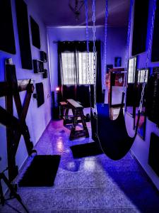 a dark room with a gym with a swing at Taboo21+ in Ashkelon