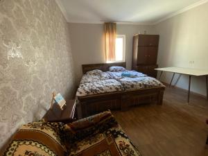 a bedroom with two beds and a couch in it at Aloha House in Akhaltsikhe