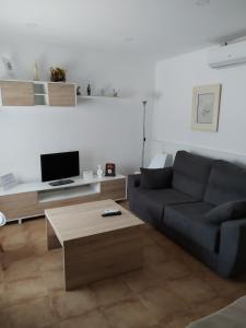 a living room with a couch and a coffee table at Casa Rural "La Muela de Alarilla" 