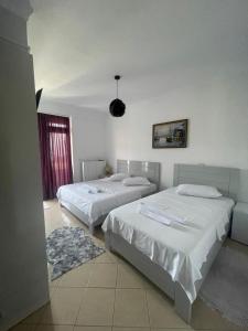 Postel nebo postele na pokoji v ubytování HOTEL VILA TOSKA