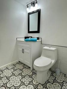 a bathroom with a white toilet and a mirror at Paradise, just a click away, style, comfort, home. in Hermitage