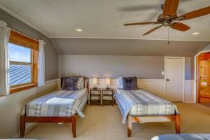 a bedroom with two beds and a ceiling fan at 678 Dichoso St in Pagosa Springs