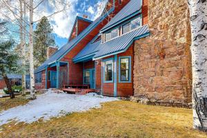 a brick house with snow on the yard at 175 Wildwood Dr Unit 3 in Pagosa Springs