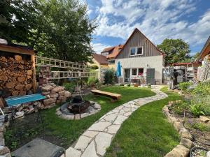 a backyard with a fire pit and a house at Ferienhaus Lilla in Nürnberg