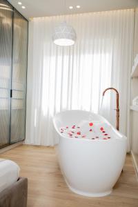 a bathroom with a white tub with hearts on it at Comfort Apartament 27 in Durrës