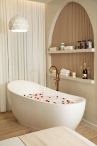 a bathroom with a white tub with hearts on it at Comfort Apartament 27 in Durrës