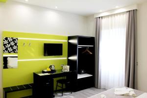 A television and/or entertainment centre at HOLYGOLD Suite ****