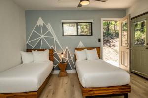 two beds in a room with a wall mural at 785 Aspenglow Blvd ("Bear's Cliff") in Pagosa Springs +42 photos