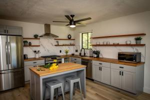 a kitchen with white cabinets and a ceiling fan at 785 Aspenglow Blvd ("Bear's Cliff") in Pagosa Springs