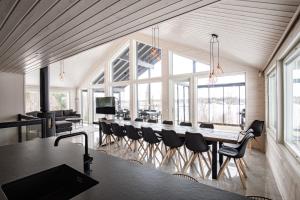 a large dining room with a long table and chairs at BestVillas Himos Finland in Jämsä